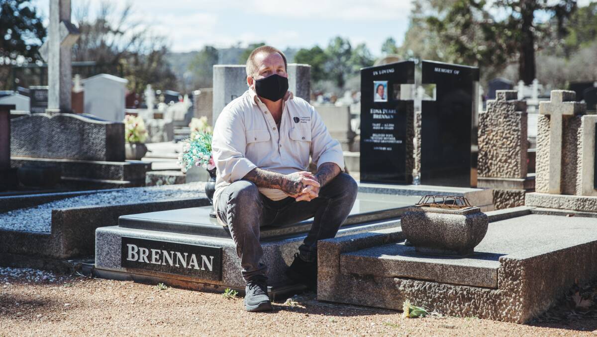 Cemetery worker Mick Brennan at the grave of his mother, Edna Brennan, whose grave he dug. Picture: Dion Georgopoulos