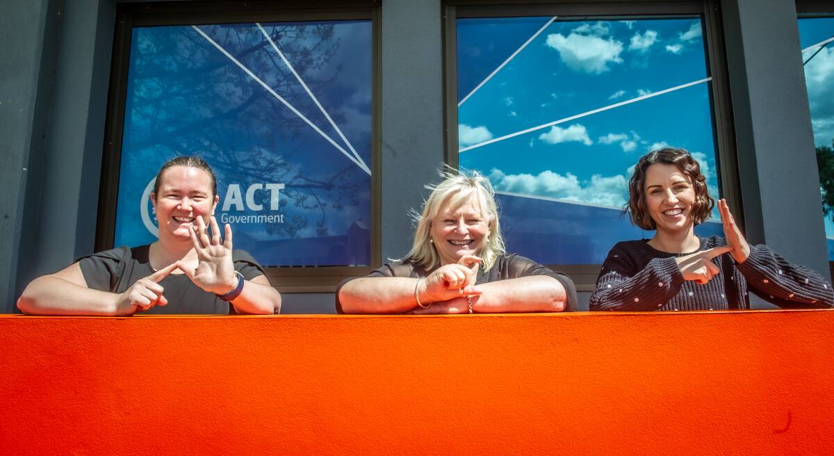 Auslan interpreters (from left) Sherrie Murray, Mandy Dolejsi and Lauren Napper-Ferrari. They are spelling out ACT. Picture: Karleen Minney
