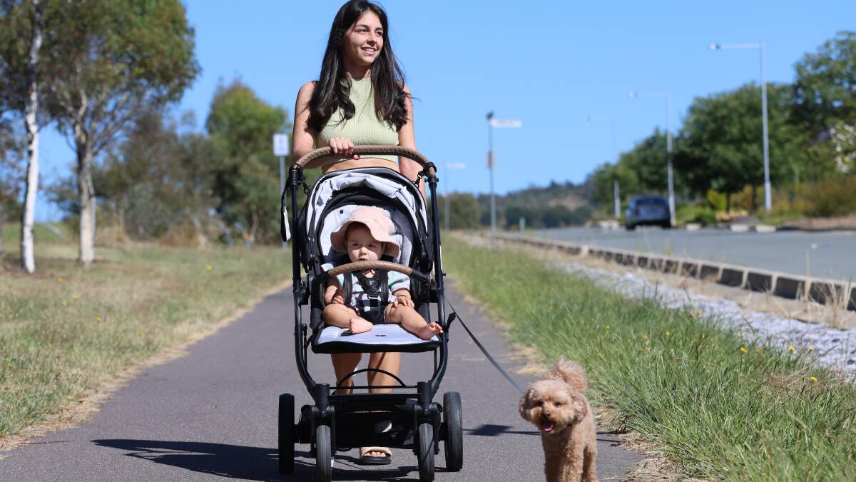Talia Mihailakis walking in Wright with her daughter Pia and dog Sunny.