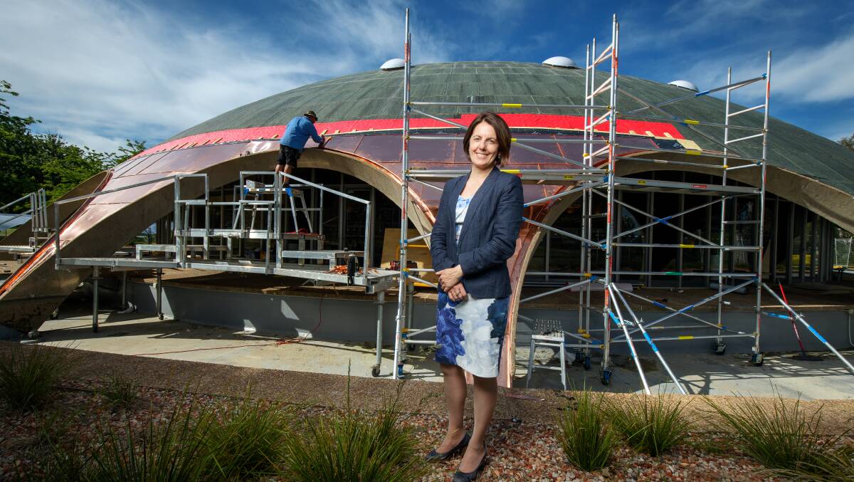 Australian Academy of Science chief executive Anna-Maria Arabia and the Dome as the new roof went on. Picture: Sitthixay Ditthavong