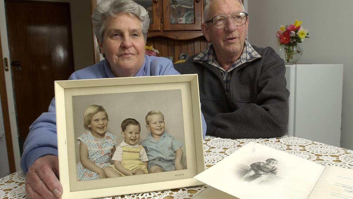 Violet and Brian Redston with a 1960's photograph of three of their four children, Anne, Peter and Allen (far right). Picture by Graham Tidy