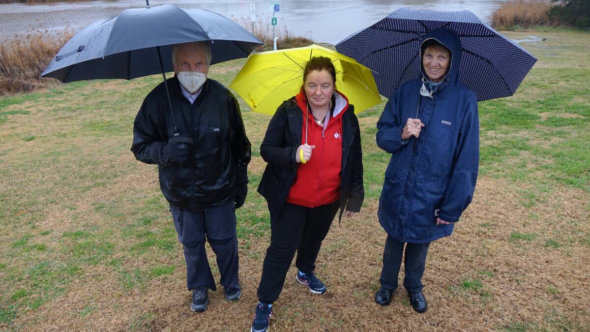 Undeterred by the weather, (left to right) Neil Ferguson, Sueanne MacKinnon and Penny Daniel did their weekly Thursday walk as part of the Queanbeyan branch of the Heart Foundation. Picture: Steve Evans