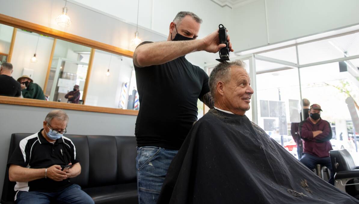 David Tutalo and customer Murray Masters at the Royal Barber Shop. Picture: Sitthixay Ditthavong