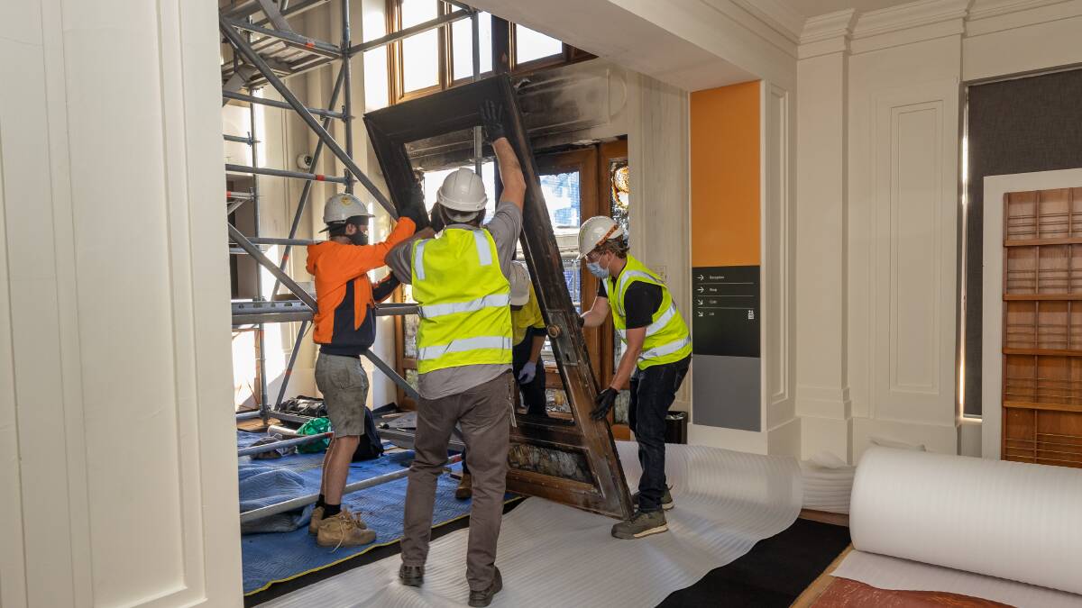 Conservators remove the front doors of Old Parliament House for restoration. Picture: Sitthixay Ditthavong