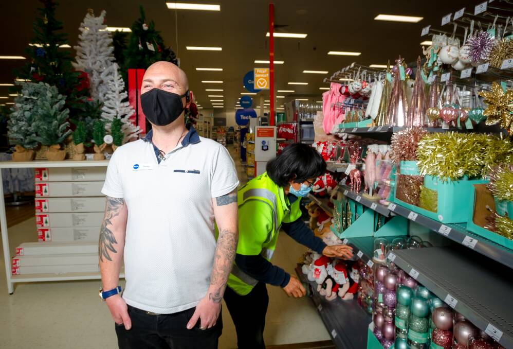 Big W store manager, Corey Moon, with (behind him) Tanong Chitasing scanning Christmas goods. Picture: Elesa Kurtz