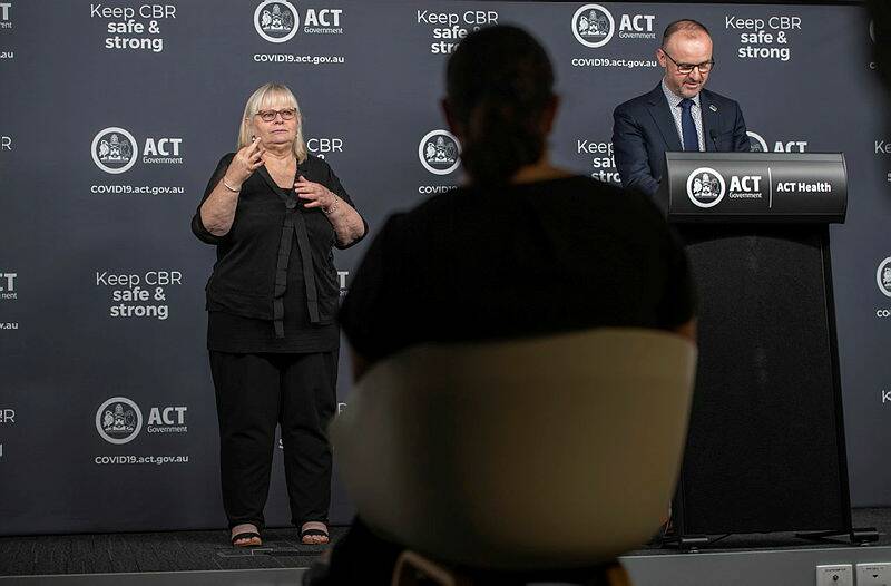 The interpreters work in tandem. Mandy Tolejsi is interpreting Andrew Barr's statement from the stage, and Sheree Murray is sitting to prompt. Picture: Karleen Minney
