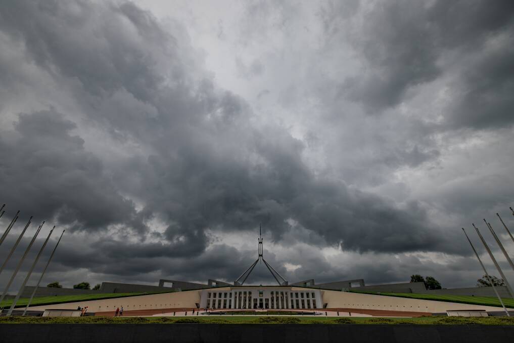 Storm clouds gather over Parliament House on Tuesday. Picture: Sitthixay Ditthavong