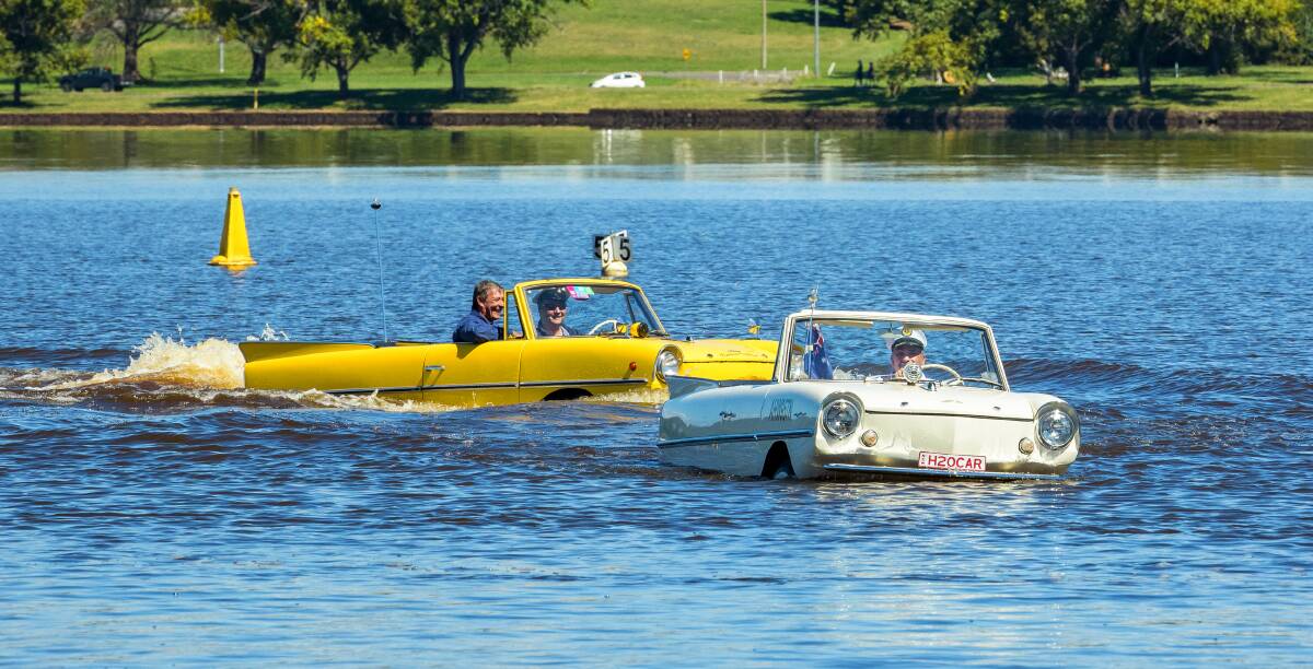 Ian Oliver and Tony Nassar spend some time on the lake in their amphicars on Friday. Picture: Sitthixay Ditthavong