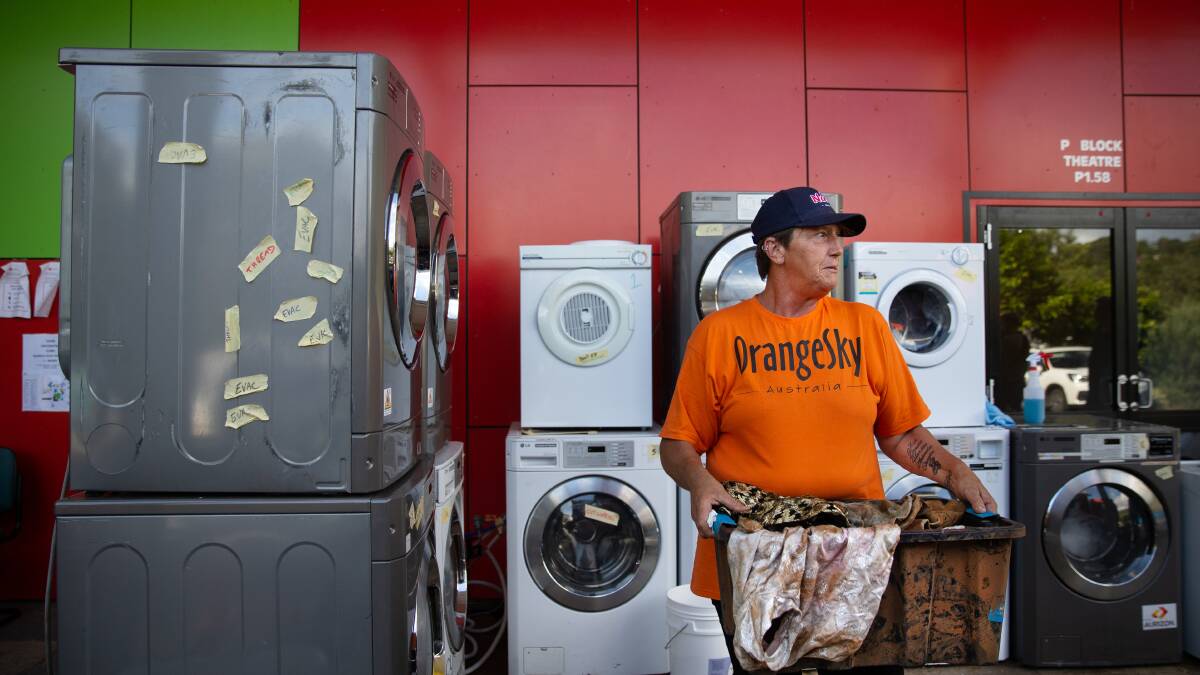 Anna Horvat helps out at the Orange Sky laundry at the Lismore Evacuation Centre. She says the threat of more rain causes great anxiety. Photo: Marina Neil