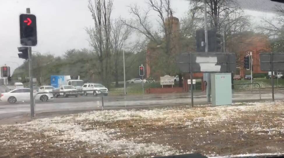 Hail blanketed the intersection of Captain Cook Crescent and Canberra Avenue on Monday. Picture: Mark Kenny
