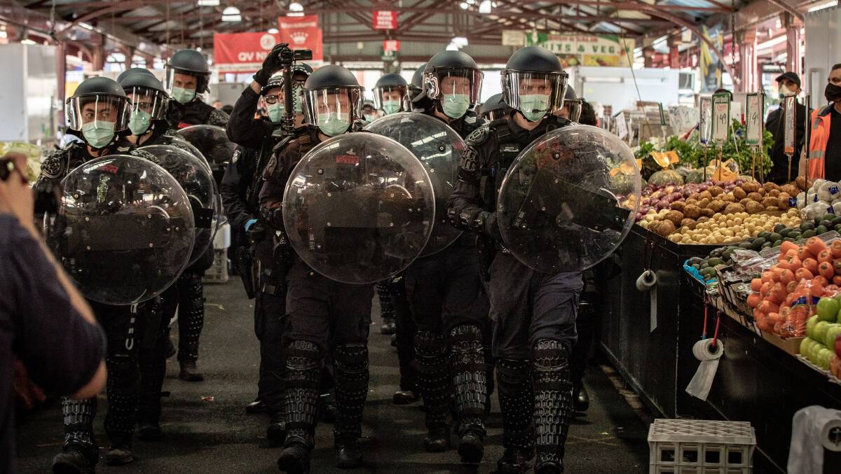 Riot police make their way through the Queen Victoria Market in Melbourne on September 13. Picture: Getty Images