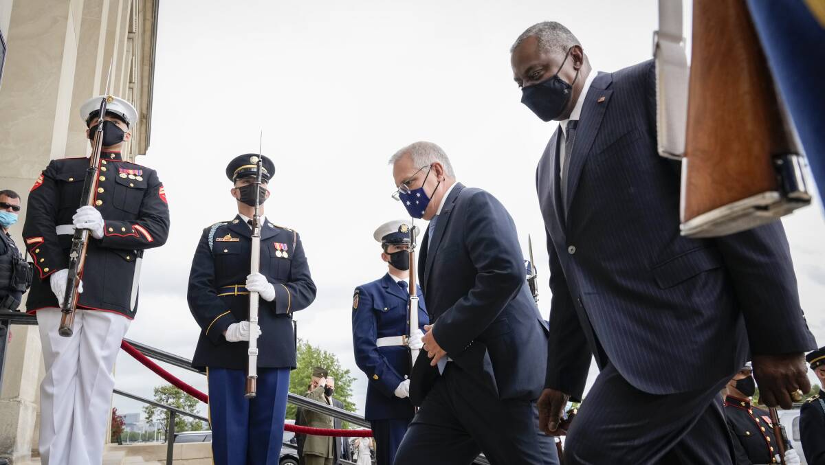 Prime Minister Scott Morrison and US Defense Secretary Lloyd Austin walk past a military honour guard at the Pentagon last Wednesday. Picture: Getty Images