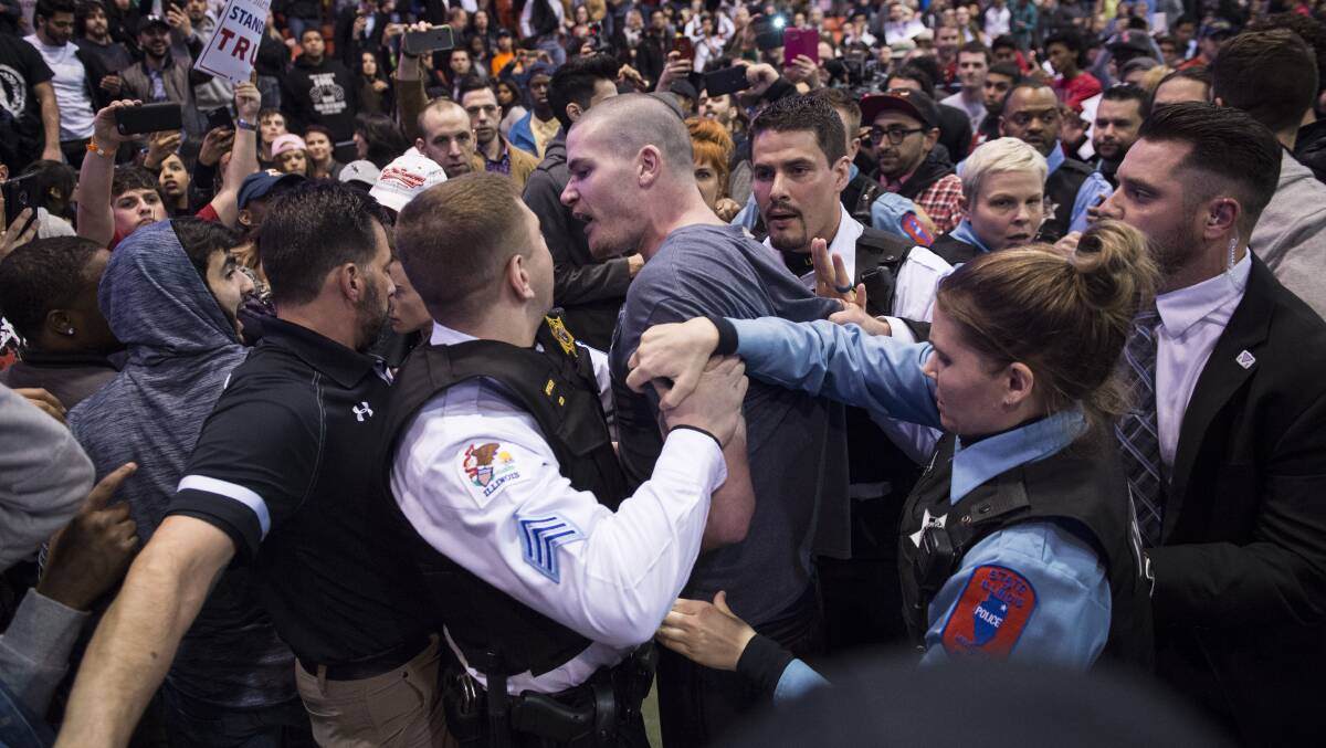 Protesters and Trump supporters clash after an event was postponed where then-candidate Donald Trump was to speak at the University of Illinois in 2016. Picture: Getty Images