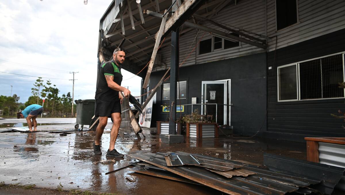 Grant McPherson removes debris from his flood-affected mechanic business in Lismore on March 2. Picture: Getty Images