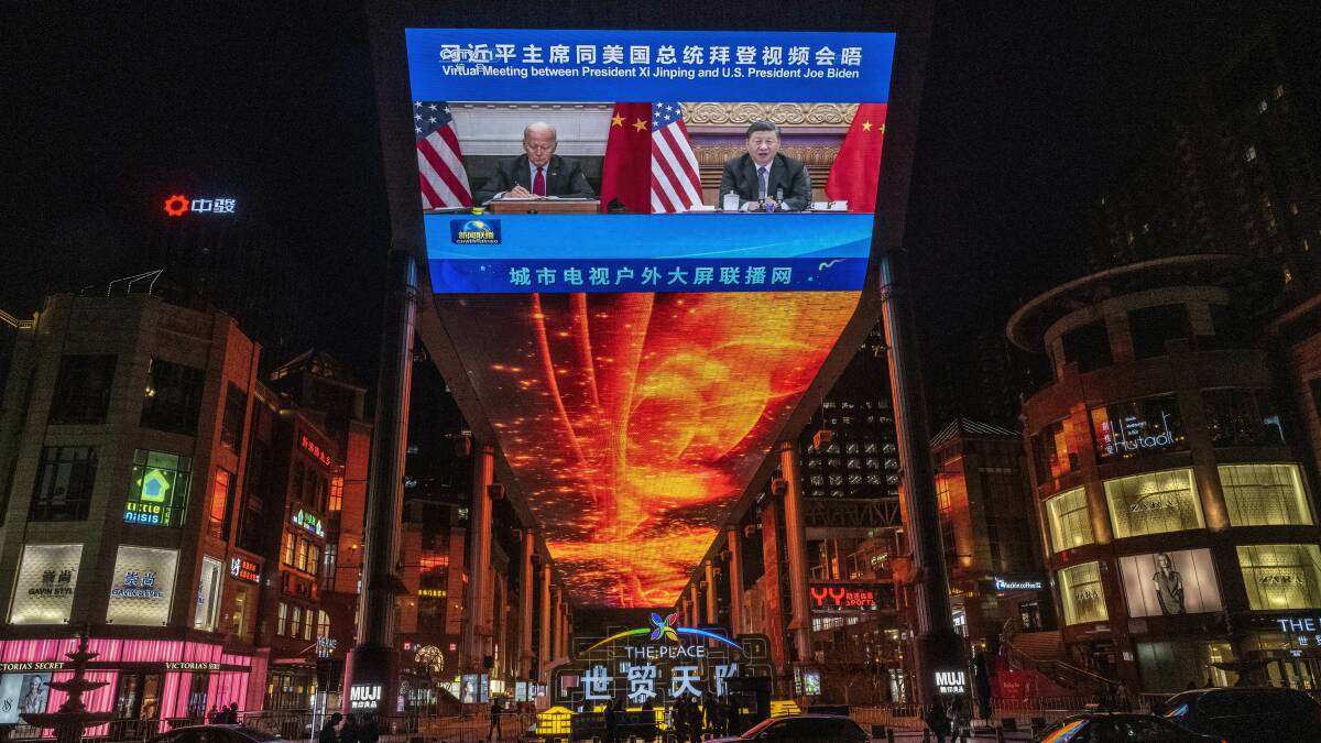 A large screen in Beijing displays United States President Joe Biden, left, and China's President Xi Jinping during a virtual summit on Tuesday. Picture: Getty Images