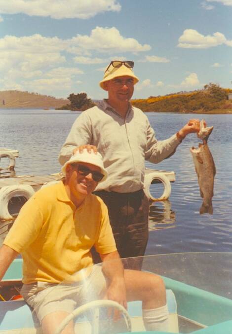 Ockie Wallace and Max Browne catch a fish on Eucumbene before jumping on a joy flight on the Beachcomber flying boat. Looks like it was the era of the terry towelling bucket hat. Picture: Supplied