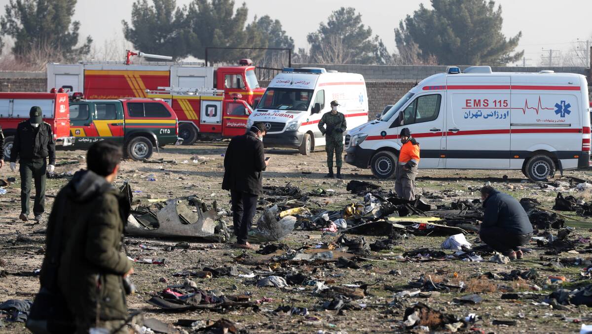 Rescue workers search the scene where the Ukrainian airliner crashed in Tehran on Wednesday. Picture: Shutterstock