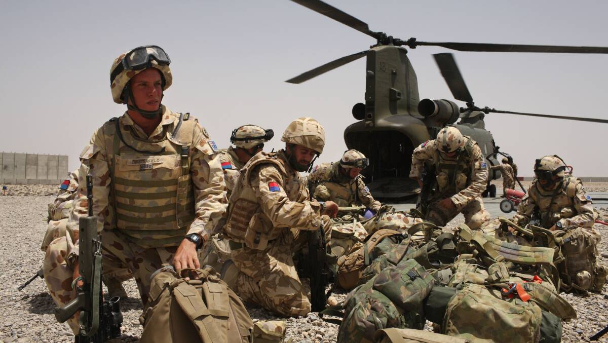 Australian Army soldiers from the 8th/12th Medium Regiment deploy from a Royal Air Force Chinook helicopter at Camp Bastion, Helmand Province, Afghanistan, in 2008. Picture: Getty Images
