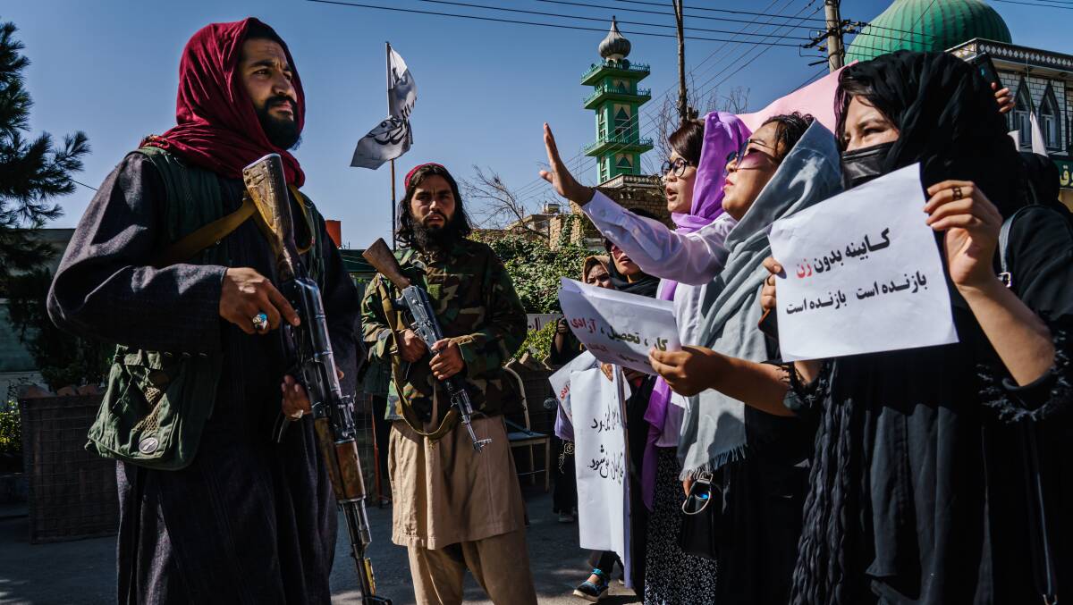 Taliban fighters stop the advance of protesters marching in Kabul a day after the Taliban announced their new all-male interim government, with no representation for women and ethnic minority groups. Picture: Getty Images