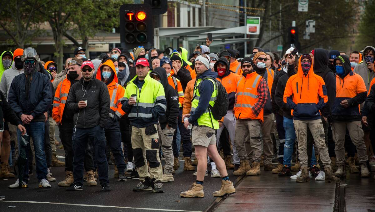 Construction workers block the intersection of Elizabeth and Victoria streets in Melbourne on Tuesday. Picture: Getty Images
