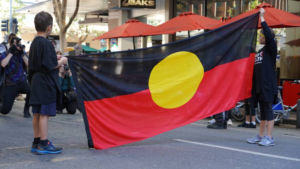 The Aboriginal flag at a protest in Brisbane earlier this year. Picture: Shutterstock