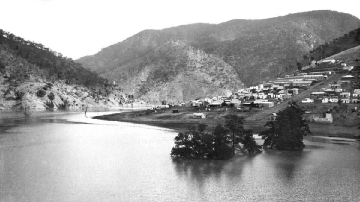 Barren Jack Village circa 1912. Note the partly submerged trees in the foreground and the local produce store on the far right of the photograph being dismantled before it was flooded by rising waters. Picture: CEW Bean/AWM