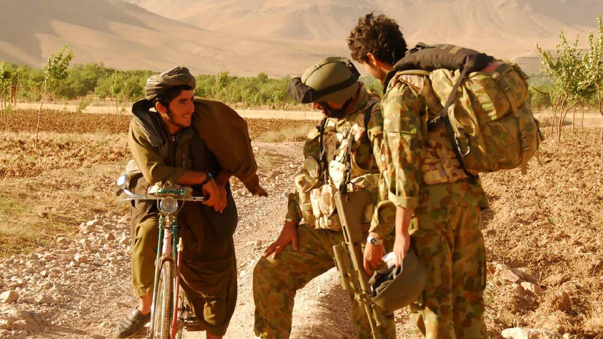An Australian major and Afghan interpreter speak with an Afghan man in the Baluchi Valley in 2009. Picture: Department of Defence