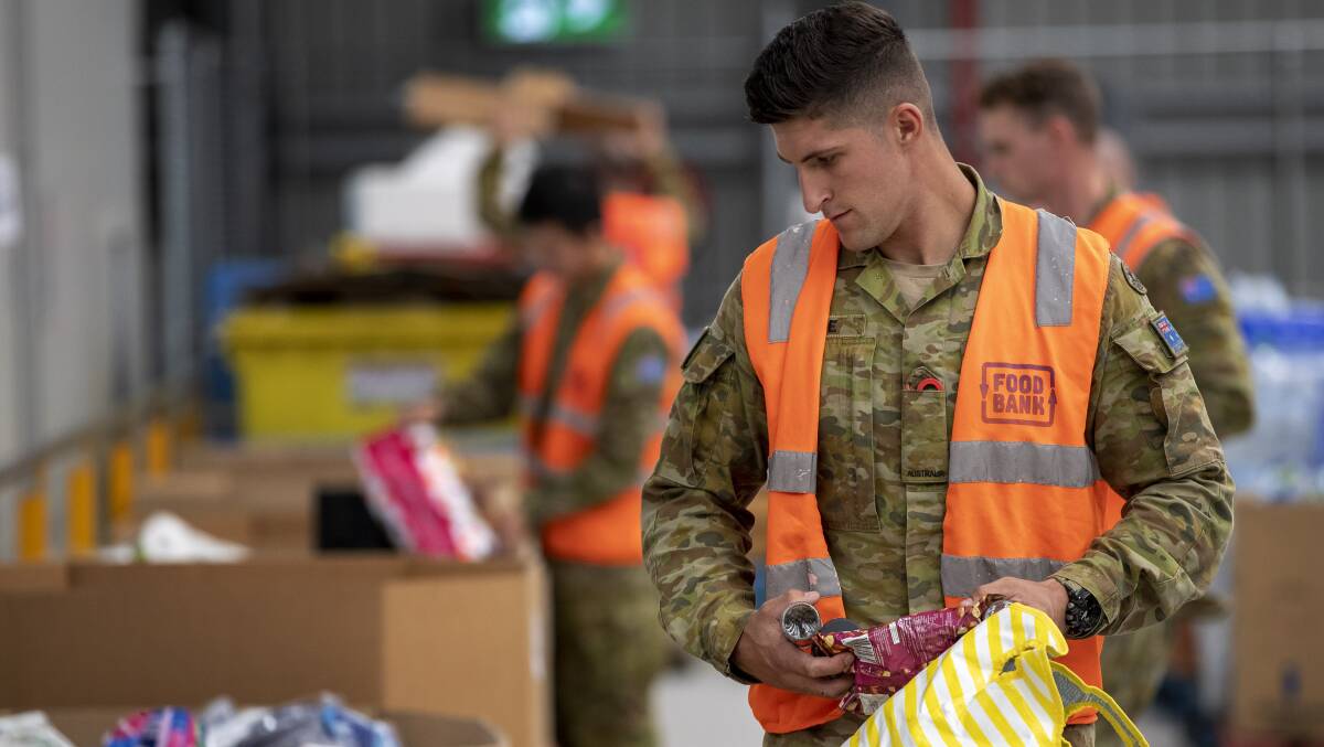 An Australian Army soldier sorts donations at a foodbank warehouse as part of Defence support for the governments COVID-19 response. Picture: Department of Defence