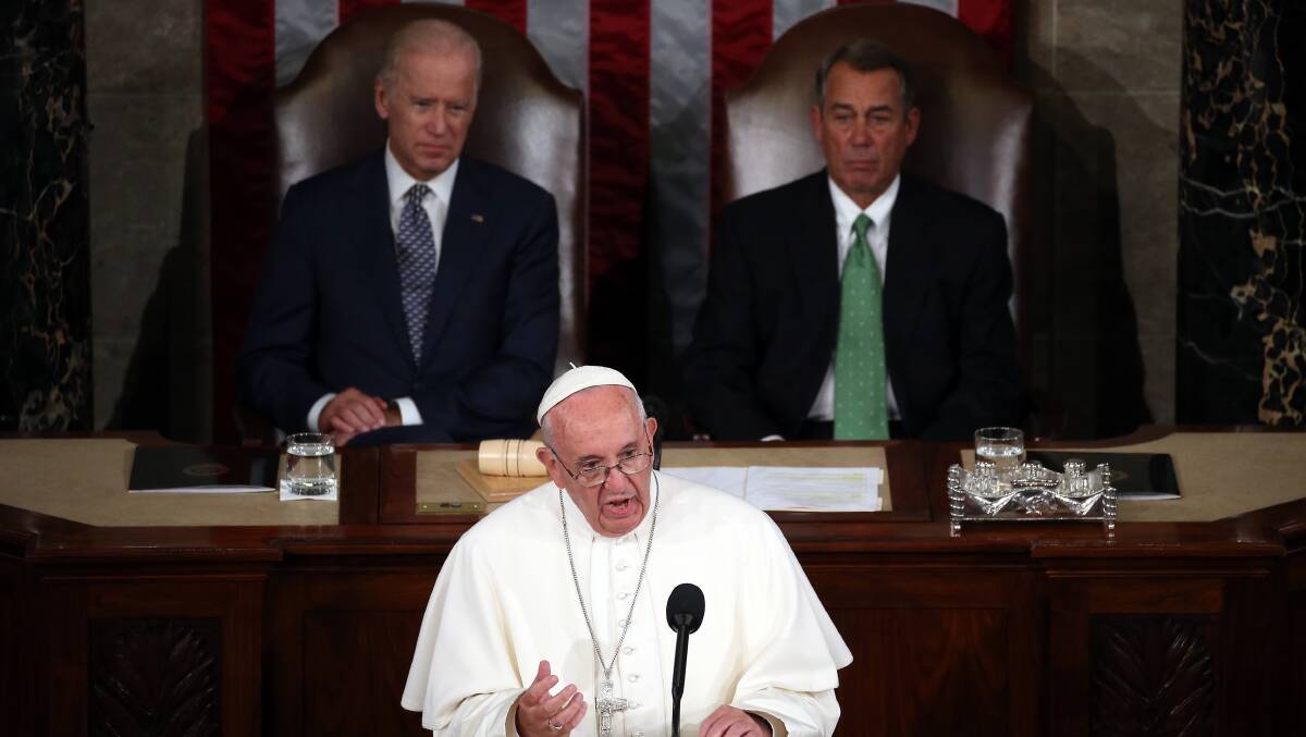 Then-vice-president Joe Biden (left) and then-Speaker John Boehner (right) look on as Pope Francis I addresses the US House of Representatives in 2015. Picture: Getty Images