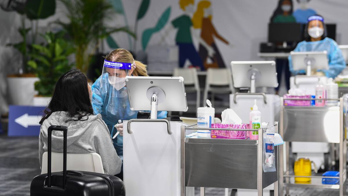 Passengers undergo COVID-19 tests in the pre-departure area at Sydney International Airport on Sunday. Picture: Getty Images