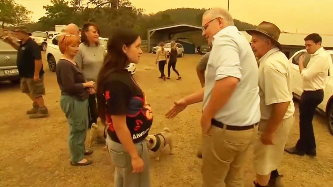 Scott Morrison goes in for an already-refused handshake while visiting bushfire-affected residents in Cobargo. Picture: Nine News