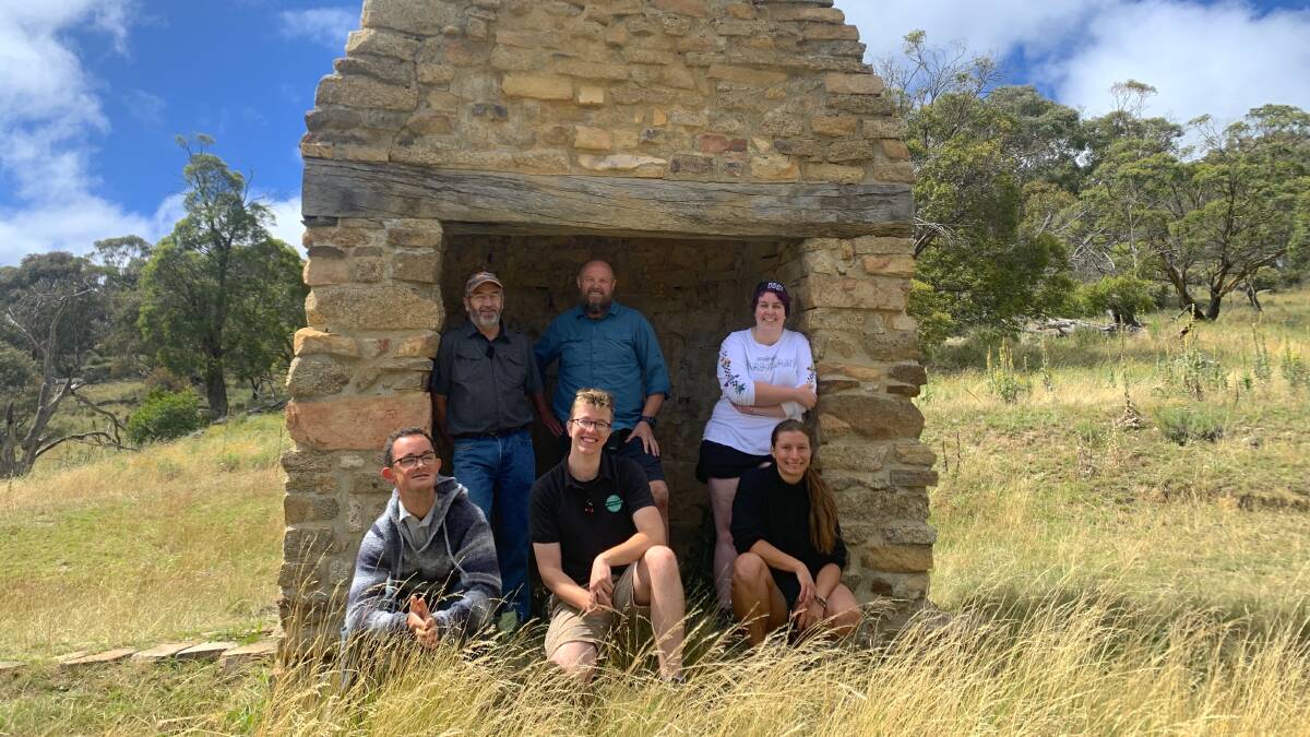 Steve Brayshaw (back left) with Stephen Cooke (back centre) and his film crew at all that remains of Bobeyan Homestead, the stone chimney. Picture: Tim the Yowie Man