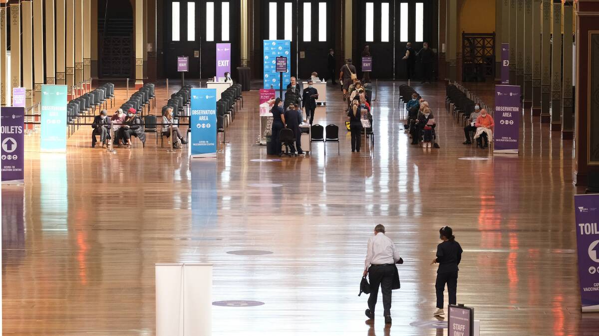 The bustling mass vaccination hub at the Royal Exhibition Building in Melbourne last month. About one-third of Australians say they are hesitant to get the vaccine. Picture: Getty Images