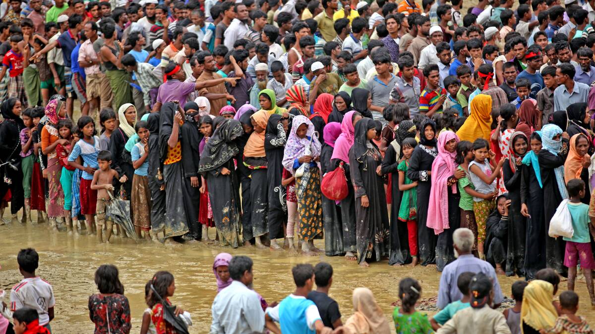 Rohingya Muslims who crossed over from Myanmar into Bangladesh, wait for their turn to collect food aid at the Cox's Bazar refugee camp in 2017. Picture: Shutterstock