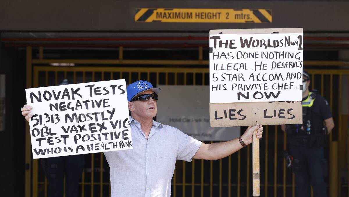 A pro-Djokovic protester stands outside the Park Hotel in Melbourne on January 10. Picture: Getty Images