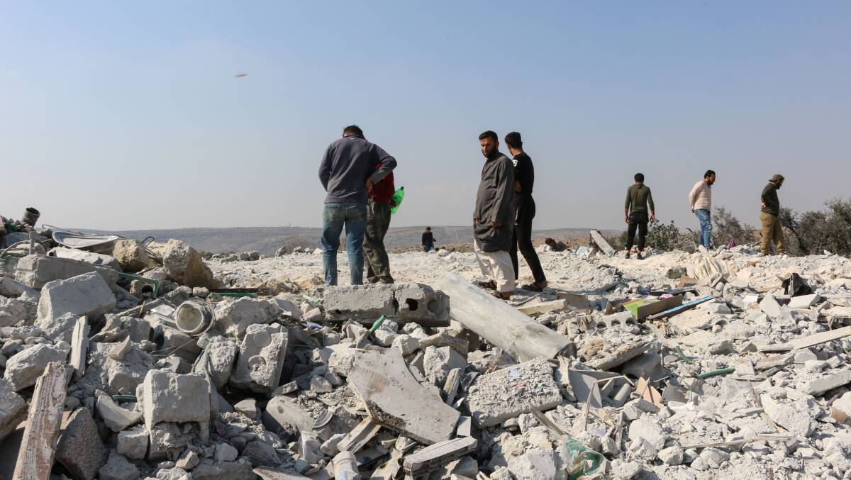 Syrians inspect the debris of a house following an alleged US-led raid targeting Islamic State leader Abu Bakr al-Baghdadi in Idlib province. Picture: Getty Images