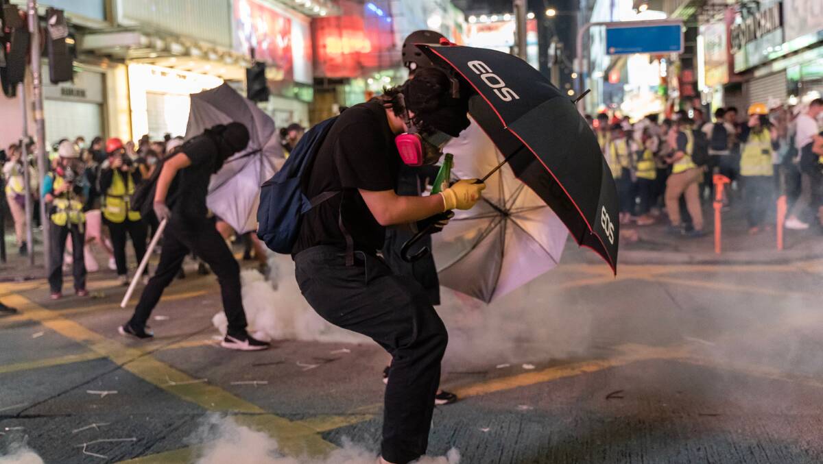 Everyday items like umbrellas are being used by protesters to shield themselves from tear gas, water cannon and other police measures. Picture: Getty Images