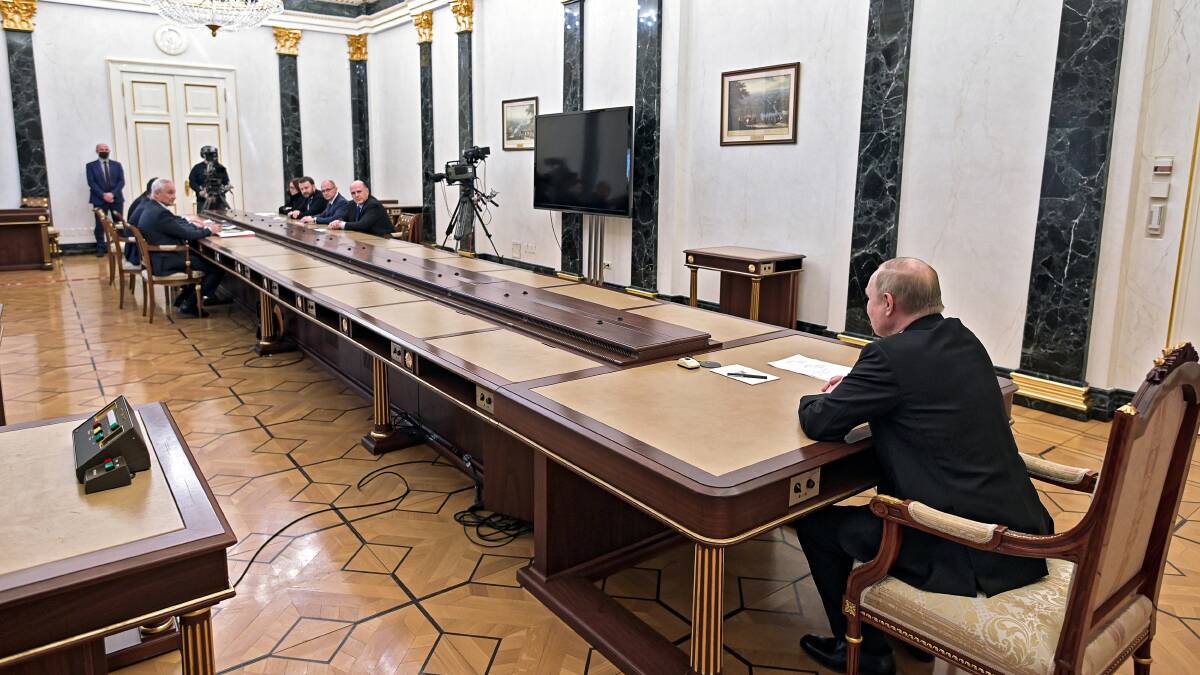Russian President Vladimir Putin, right, leads a meeting with his economic advisers in Moscow on Monday. Picture: AAP