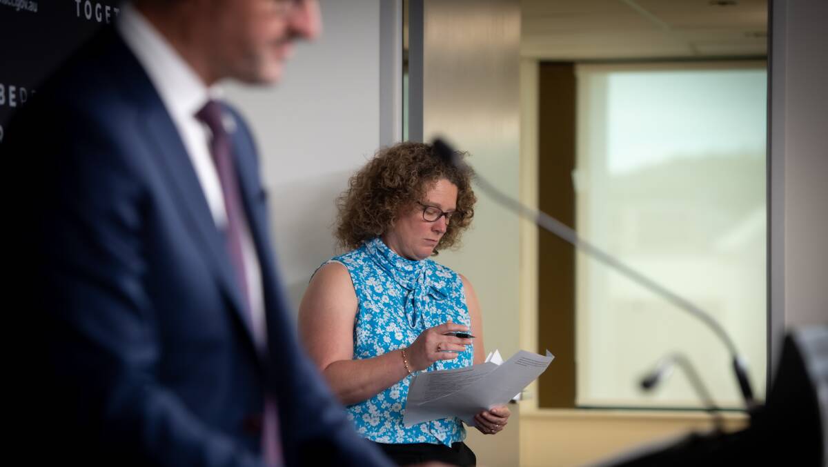 ACT chief health officer Dr Kerryn Coleman checks her notes as ACT Chief Minister Andrew Barr addresses the daily COVID-19 press conference. Picture: Karleen Minney