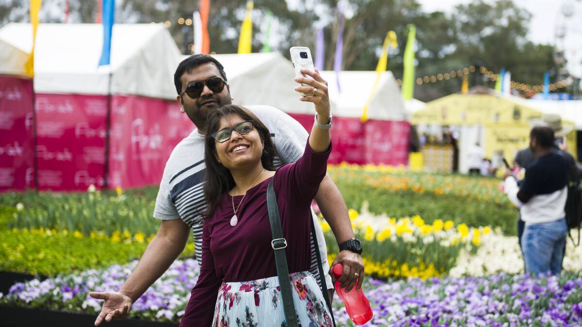 A couple take a selfie in front of the Floriade flowers at a previous year's event. Picture: Dion Georgopoulos