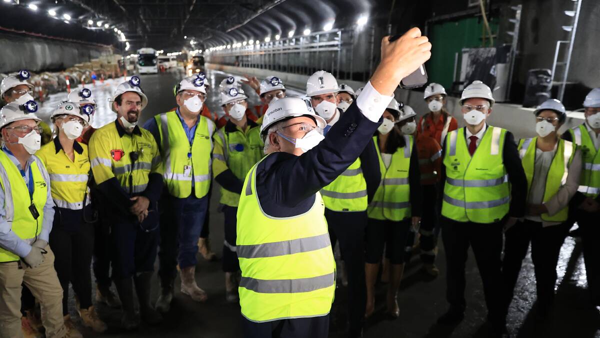 Prime Minister Scott Morrison takes a selfie with workers at the M4-M5 WestConnex link tunnel in Sydney. Picture: Getty Images