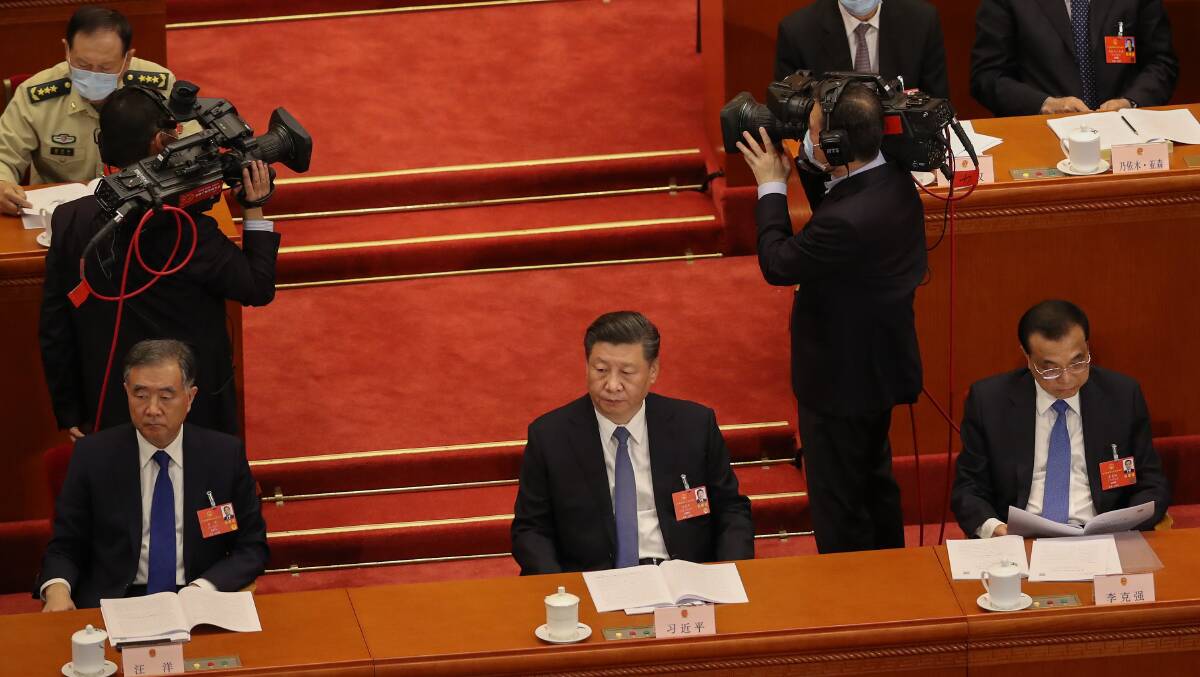 Chinese President Xi Jinping (centre) listens to a speech during the Second Plenary Session of the National People's Congress in 2020. Xi's campaign to rein in perceived capitalist excesses is increasing the government's control over the economy. Picture: Getty Images