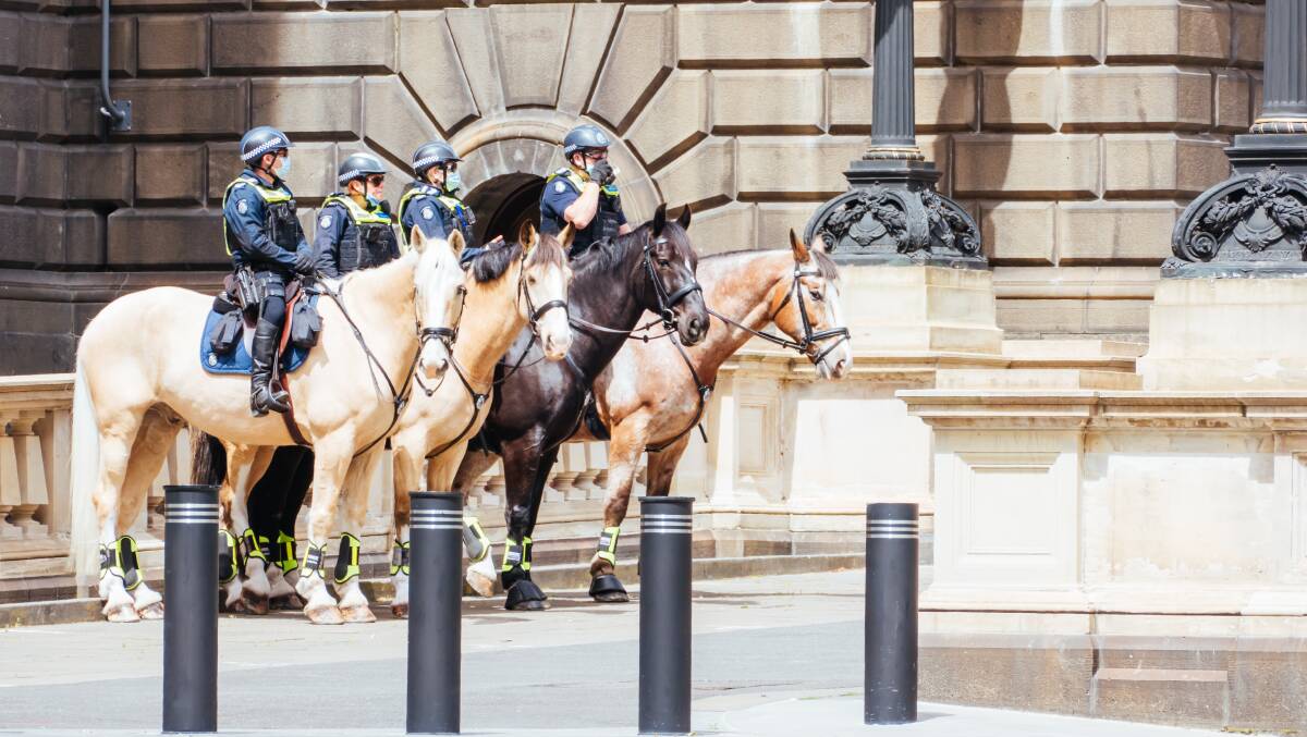 Victorian police patrol the Melbourne CBD streets on horseback checking permits during Melbourne's lockdown. Picture: Shutterstock