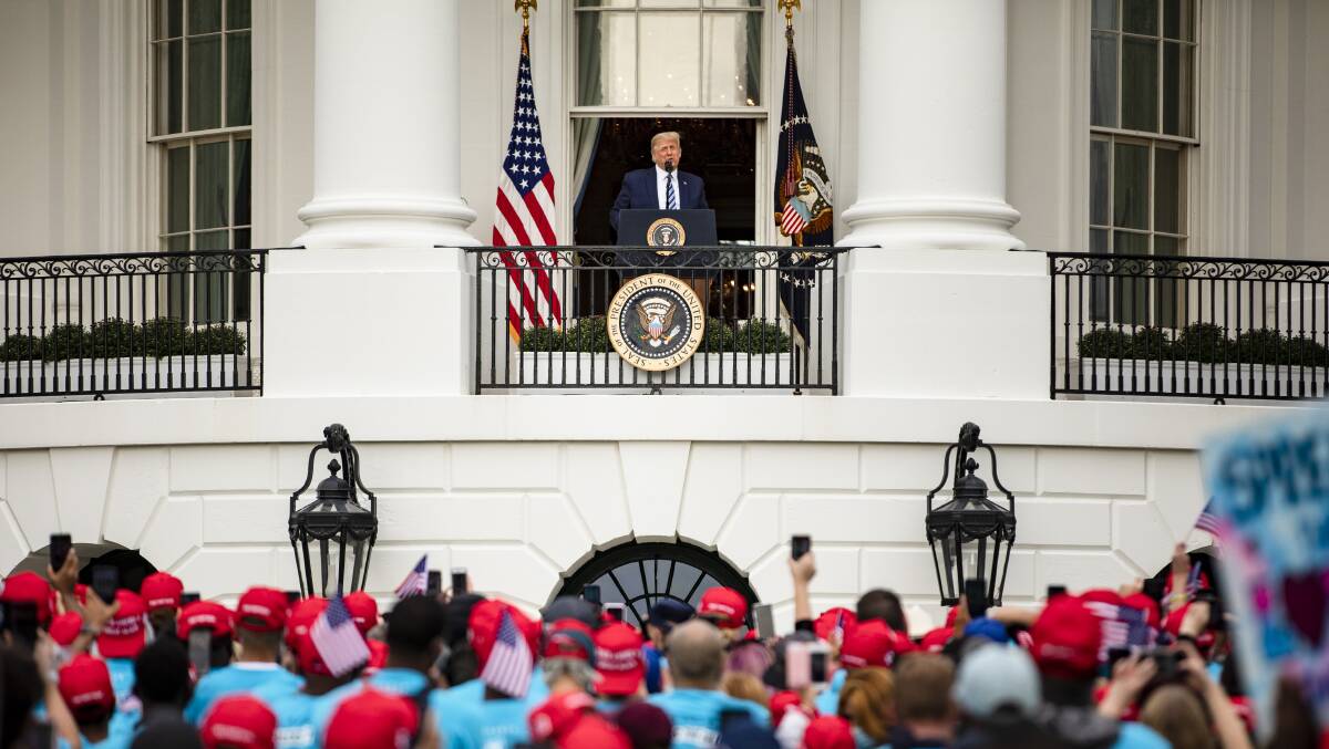 US President Donald Trump speaks to supporters from the White House balcony on October 10. Picture: Getty Images