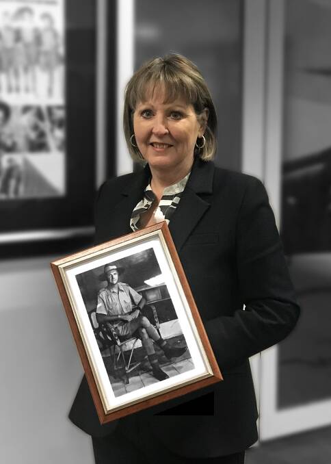 DVA secretary Liz Cosson with a picture of her grandfather, Corporal John Thomas Cosson, in 1941. Picture: Supplied