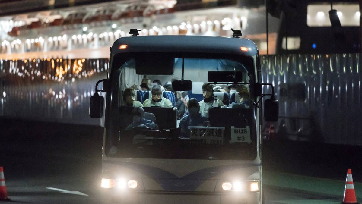 A bus carrying passengers from the quarantined Diamond Princess cruise ship in Japan before they are flown to Australia. Picture: Getty Images