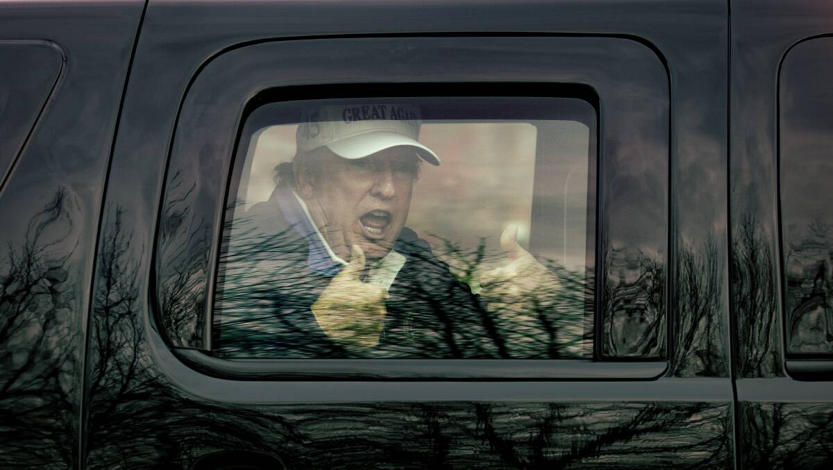 US President Donald Trump gives the thumps up to supporters as he returns from the Trump National Golf Club in Sterling, Virginia, on Sunday. Picture: Getty Images