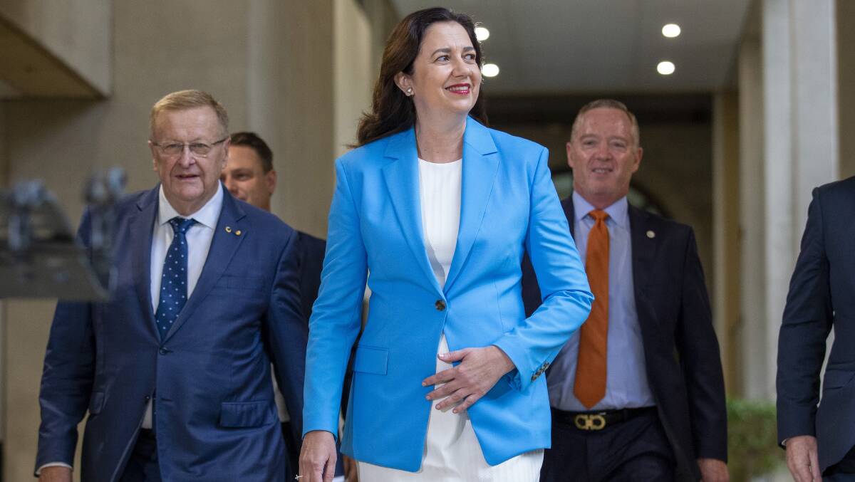 Queensland Premier Annastacia Palaszczuk arrives at a press conference flanked by Australian Olympic Committee president John Coates (left). Picture: Getty Images