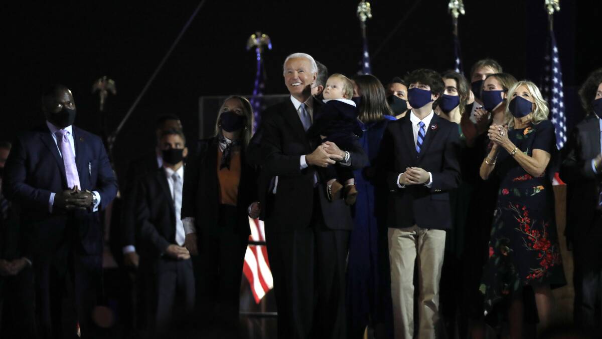 US president-elect Joe Biden stands on stage surrounded by his family after his victory speech in Wilmington, Delaware. Picture: Getty Images