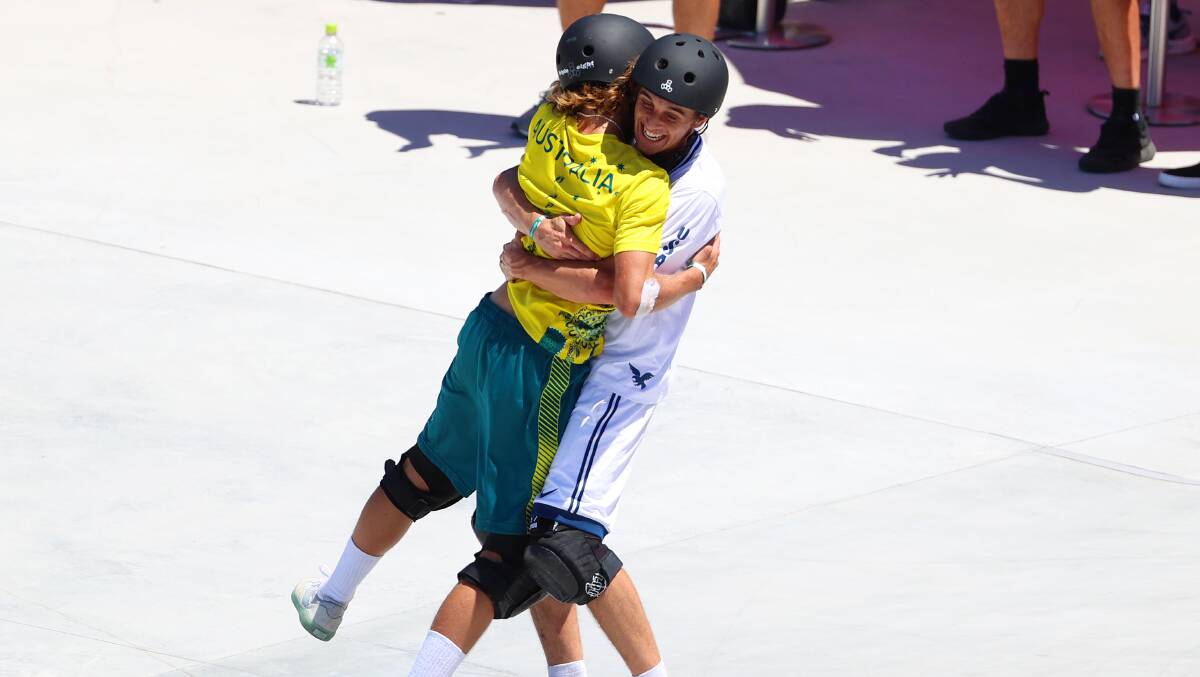Keegan Palmer of Australia celebrates with US skater Cory Juneau after his run during the Men's Park Final at the Tokyo Olympics. Picture: Getty Images
